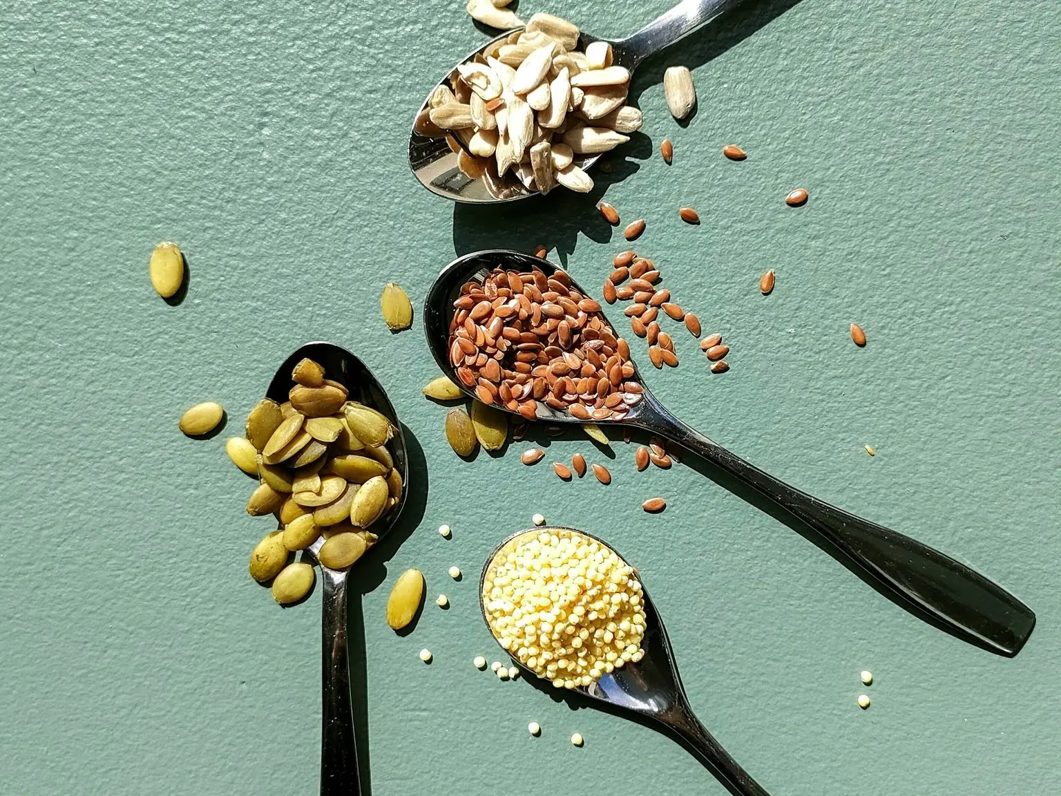 a group of spoons with food on them
